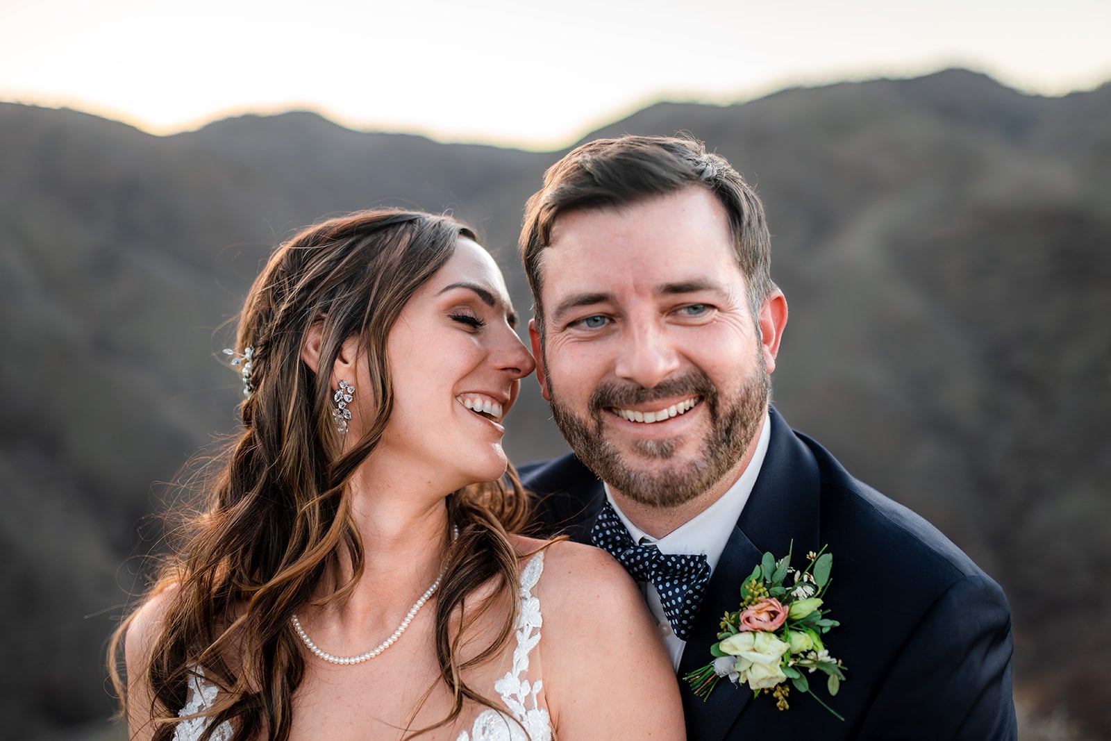 bride smiling and groom looking at each other