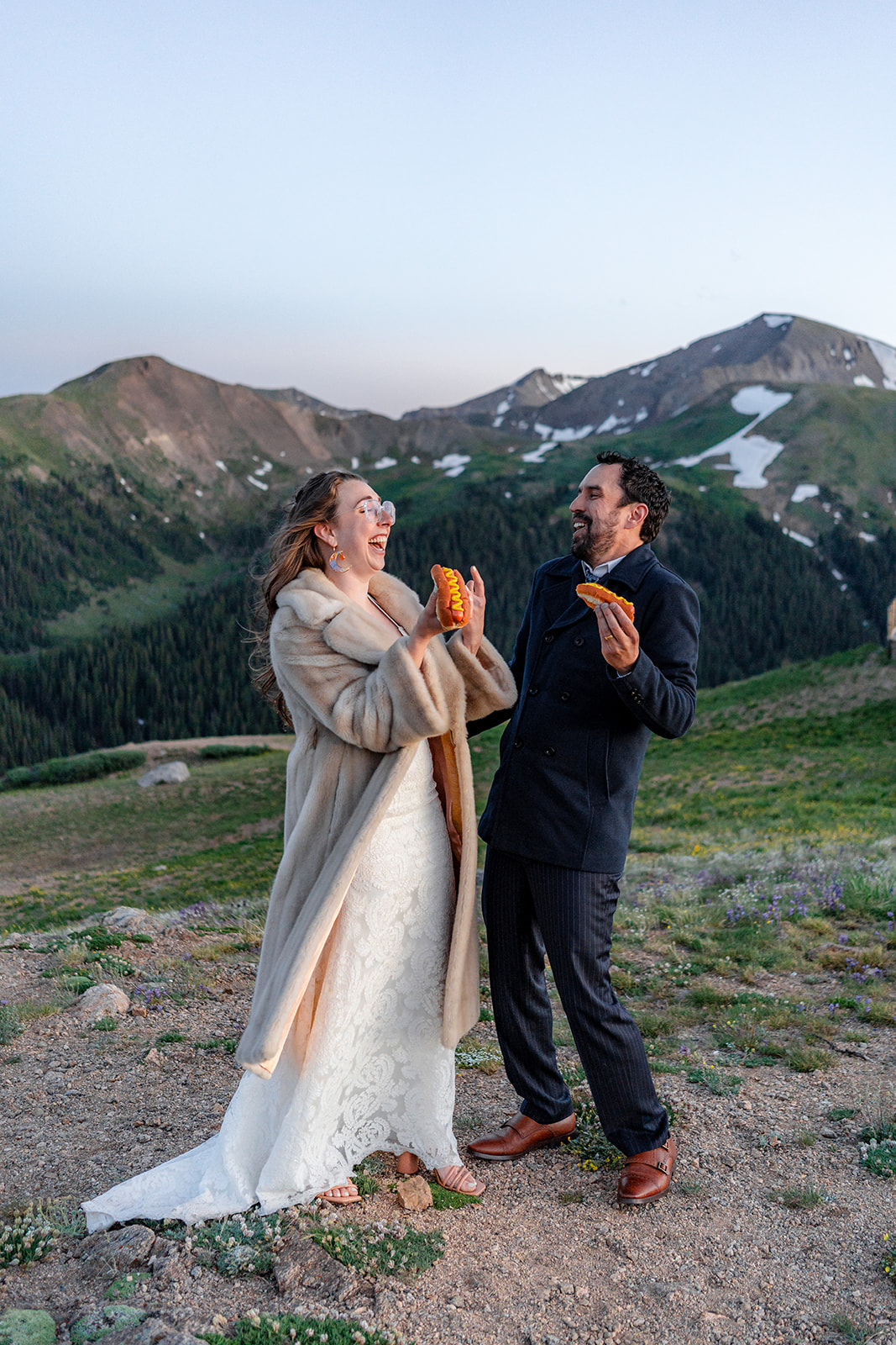 Couple enjoying hotdogs on mountain top after Colorado Elopement. 
