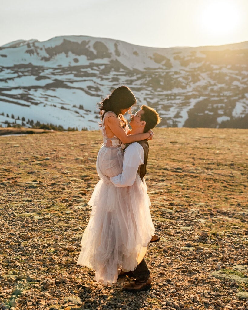 Couple embracing in a scenic landscape.