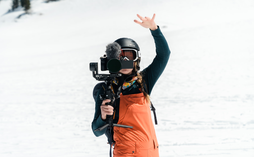 behind the scenes shot of a videographer filming with a camera rig