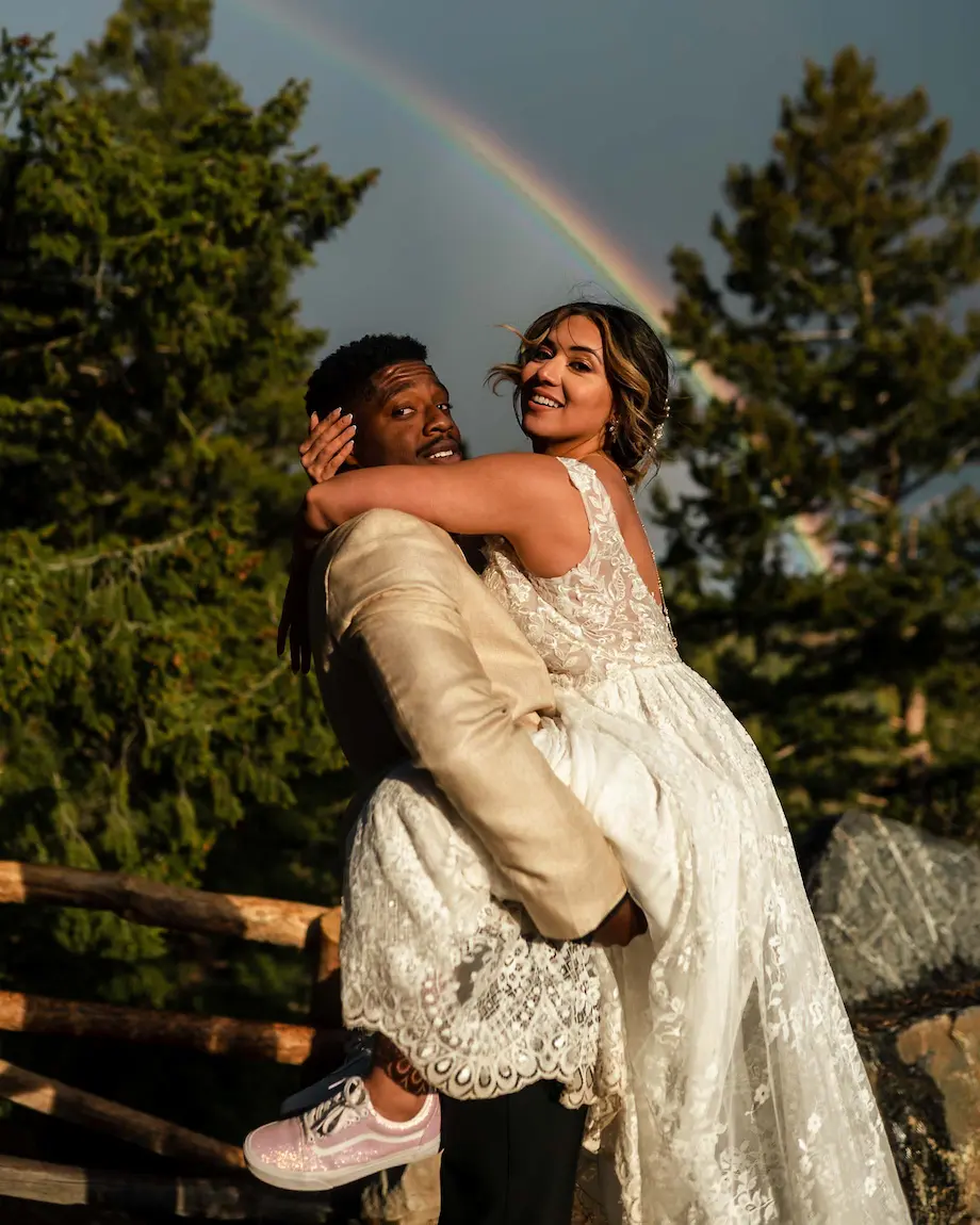 Newlyweds embracing with Colorado mountain views